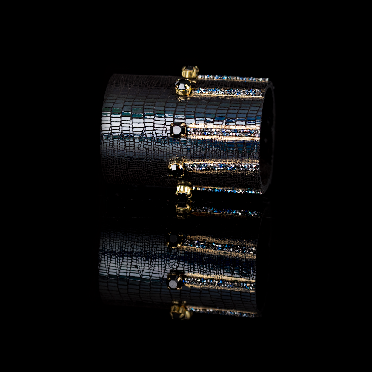 Black lizard leather cuff bracelet with gold crystal bars and blue crystal accents, handmade statement bracelet by THE DARK