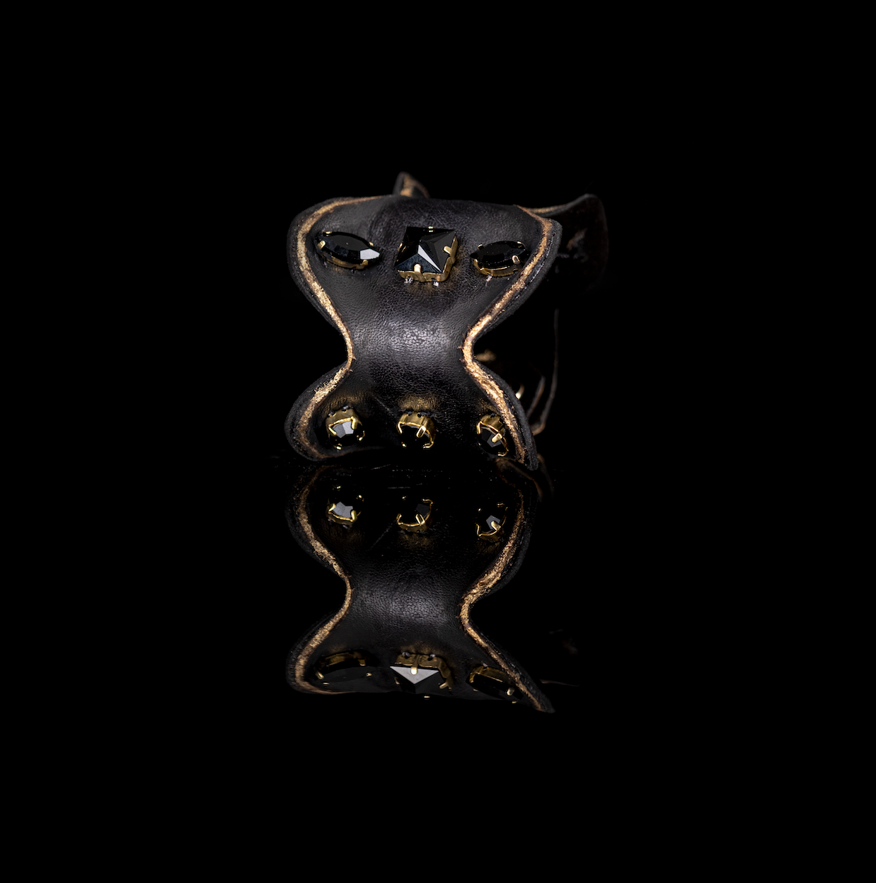 Black sculpted leather cuff bracelet with black faceted crystals and gold mounts, handmade statement bracelet by THE DARK