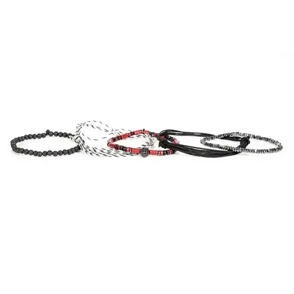 Layered men’s bracelet set featuring black braided cord, red heishi beads, faceted hematite beads, black lava stone beads, a black-and-white woven bracelet, and a pavé crystal centerpiece, displayed on a white background.