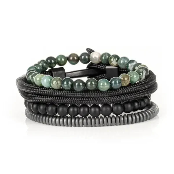 Layered men’s bracelet set featuring green natural stone beads, black matte beads, braided black cord wraps, and matte hematite disc beads, displayed on a white background.