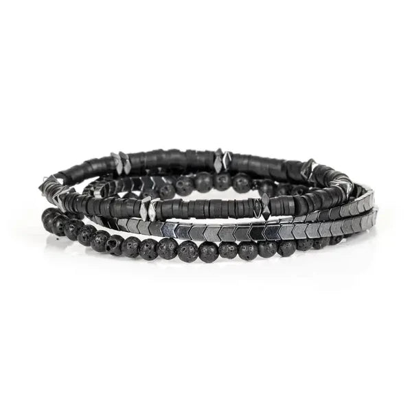Set of black beaded bracelets on a white background
