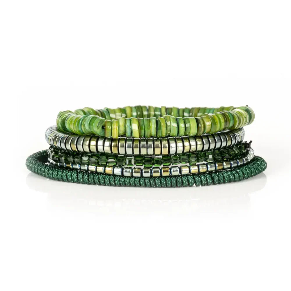 Layered men’s bracelet set featuring green shell heishi beads, metallic hematite beads, faceted dark green crystal beads, and a braided green cord bracelet, displayed on a white background.