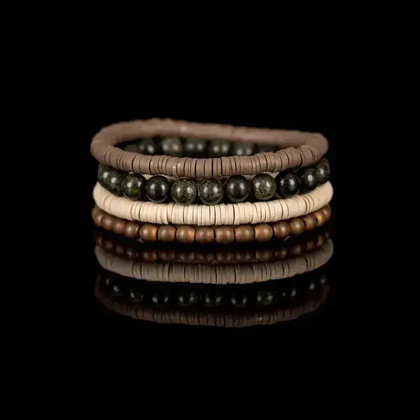 Layered men’s bracelet set featuring taupe and ivory heishi beads, natural green stone beads, and matte bronze beads on elastic strands, displayed on a white background.