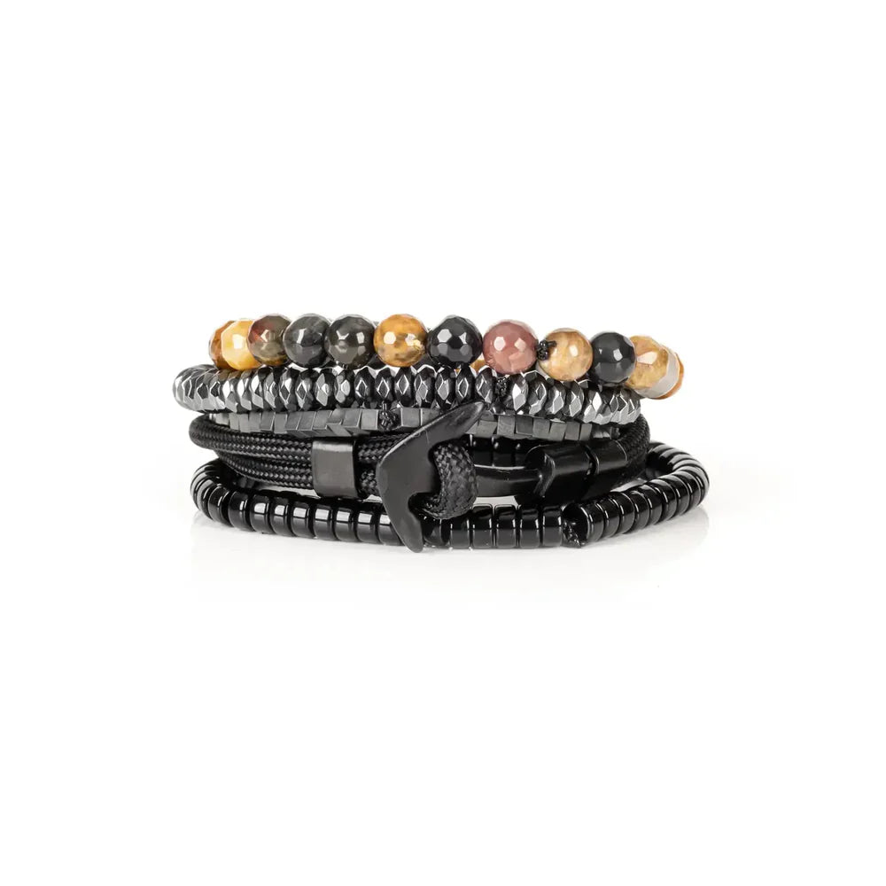 Layered men’s bracelet set featuring multicolor natural stone beads, faceted hematite beads, black hematite cube beads, braided black cord wraps, and glossy black disc beads, displayed on a white background.